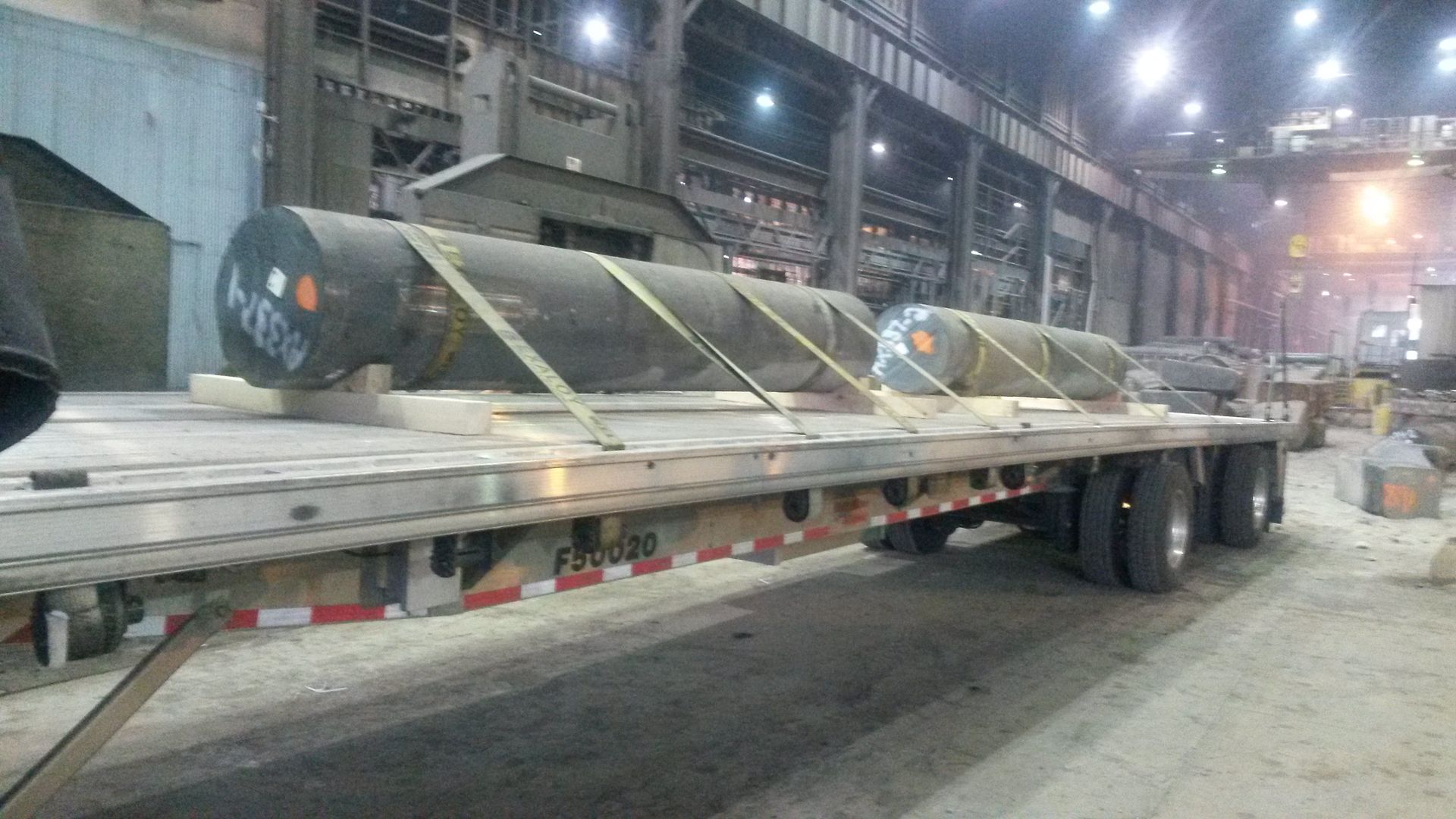 giant steel logs loaded on a flatbed